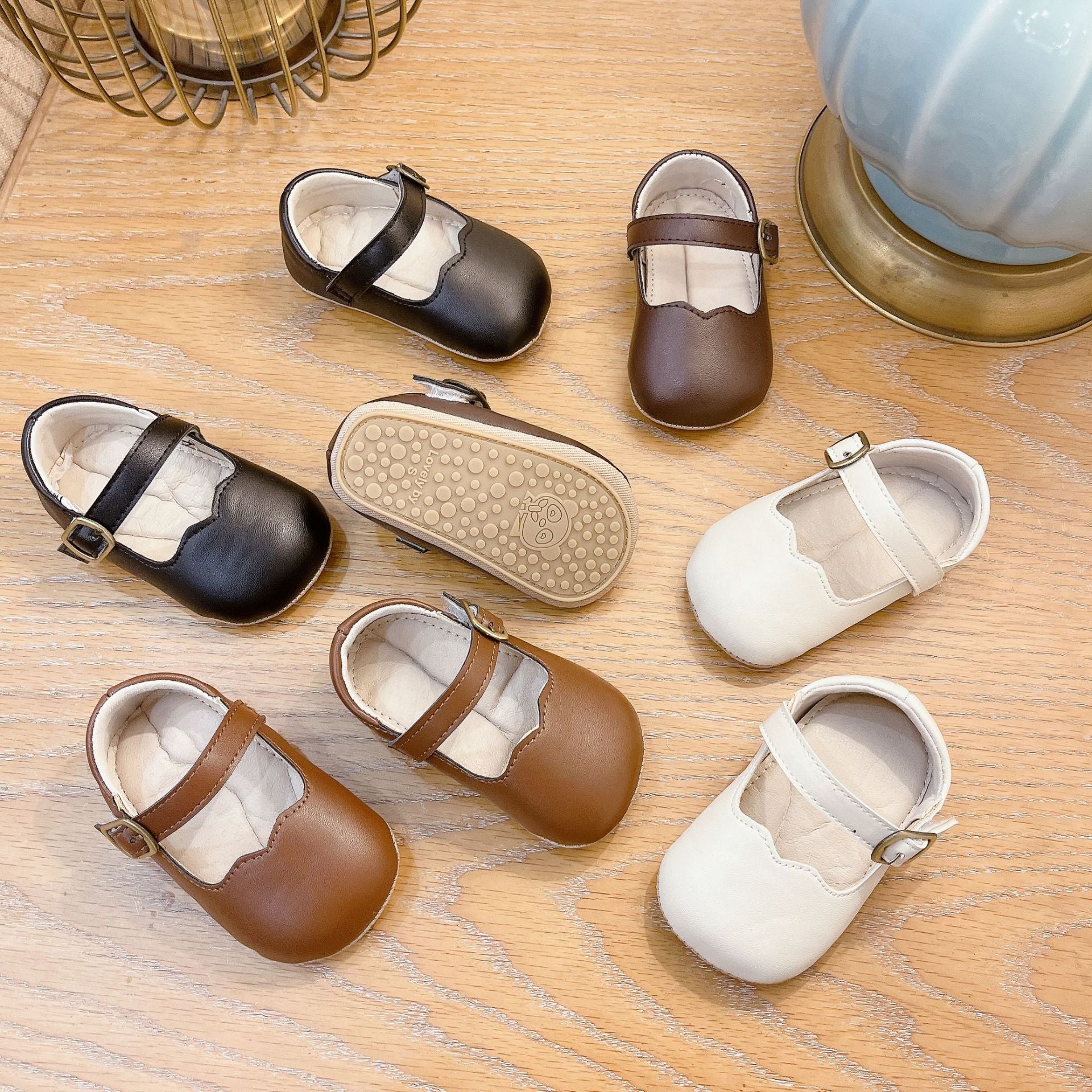 Autumn Fashion Baby Girl Solid Color Leather Toddler Shoes in white, black, khaki, and brown, showcasing their stylish design and quality material.