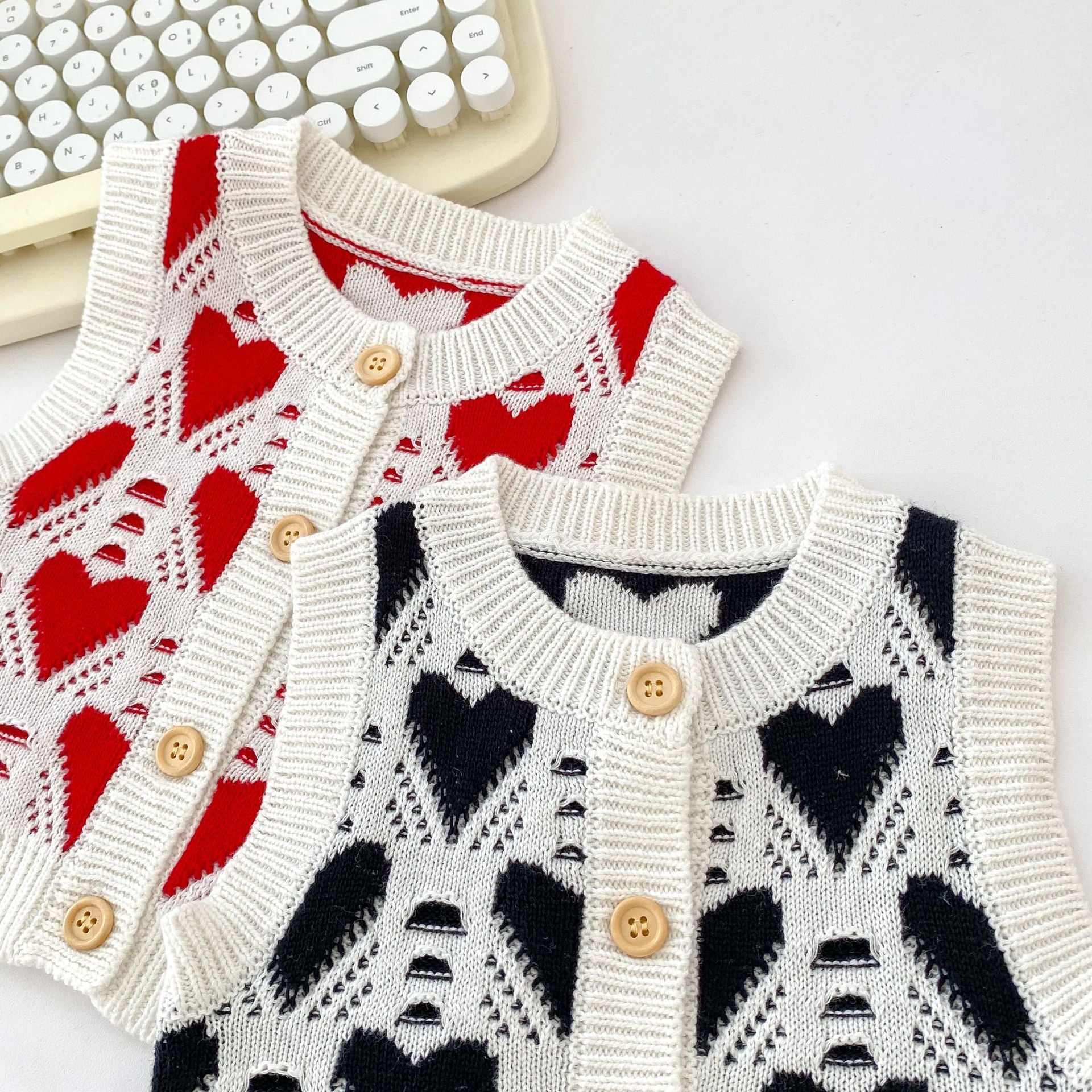 Autumn Heart Style Sleeveless Knitwear Cardigan in black and red, featuring a heart pattern, perfect for babies.