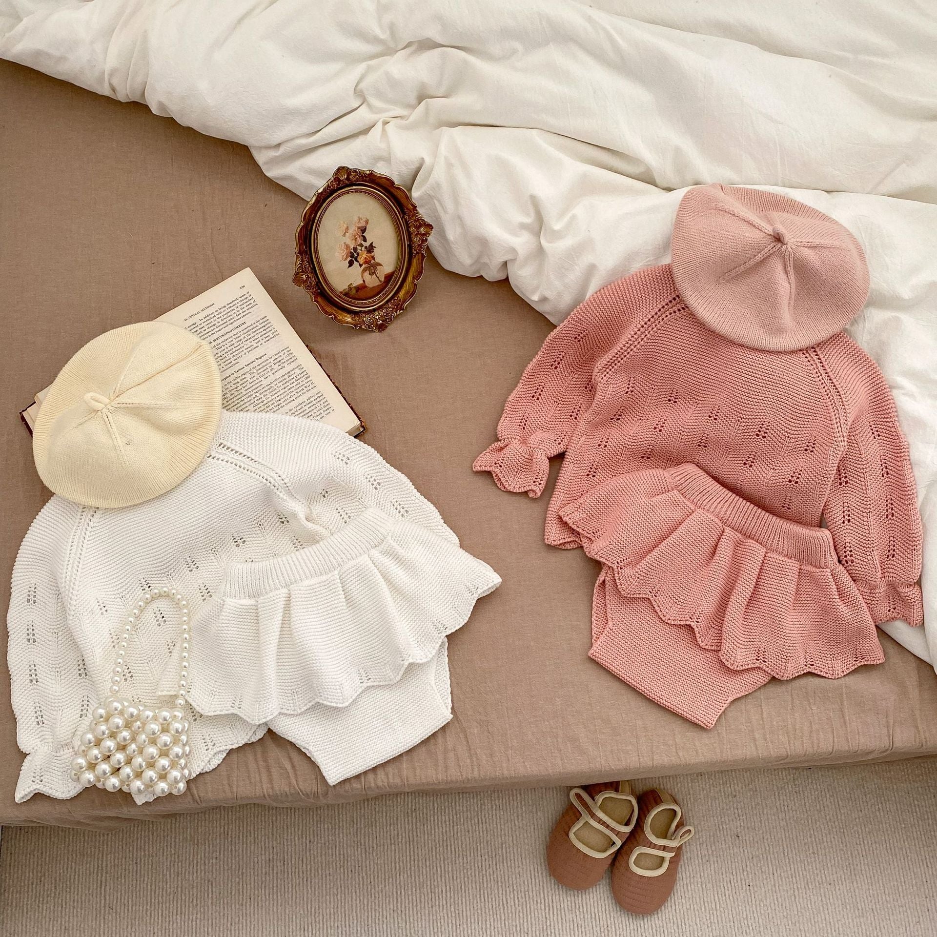 Autumn Hollow Carved Design Solid Color Knitted Sets in white and pink for baby girls, showcasing a cozy and stylish design.