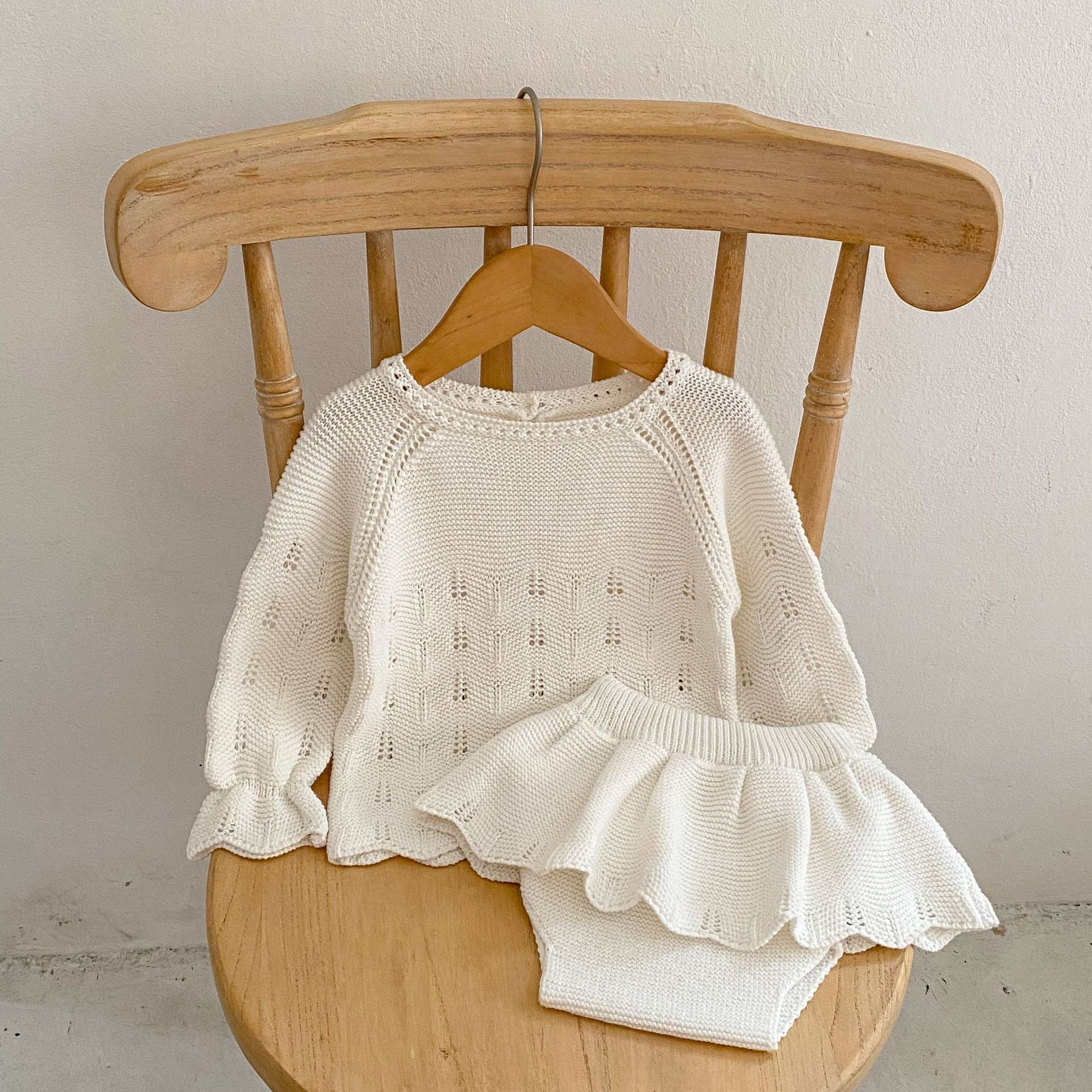 Autumn Hollow Carved Design Solid Color Knitted Sets in white and pink for baby girls, showcasing a cozy and stylish design.