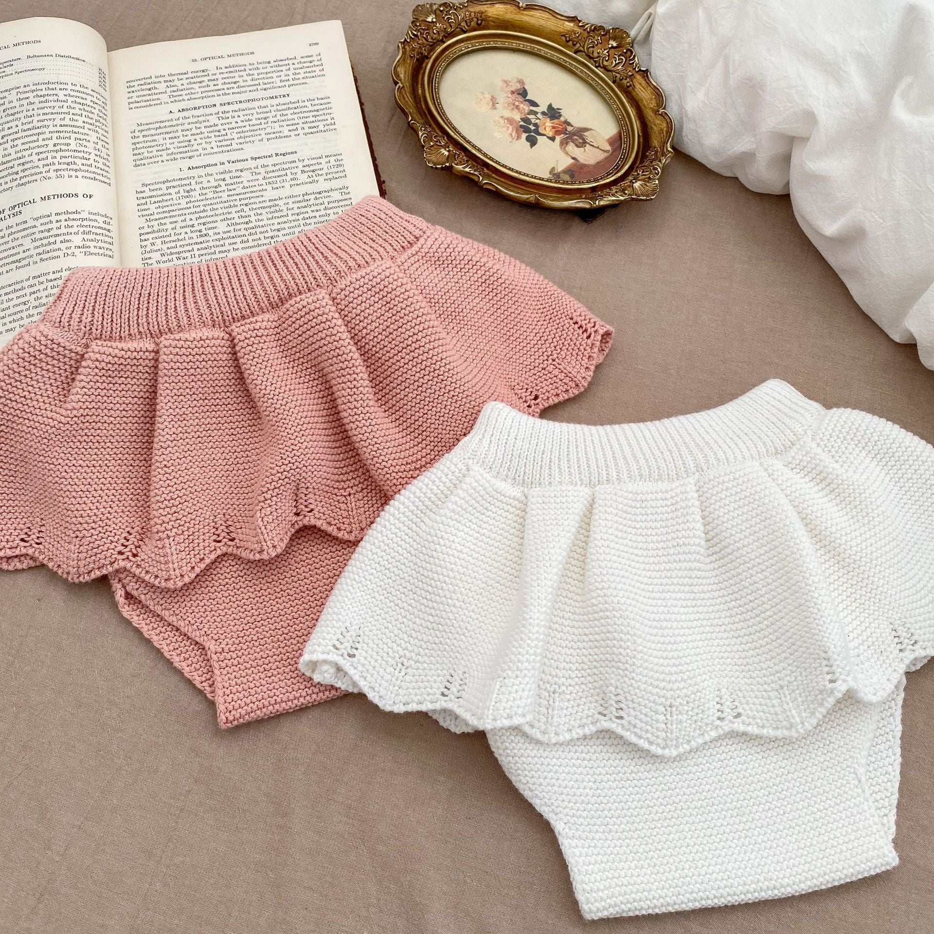 Autumn Hollow Carved Design Solid Color Knitted Sets in white and pink for baby girls, showcasing a cozy and stylish design.