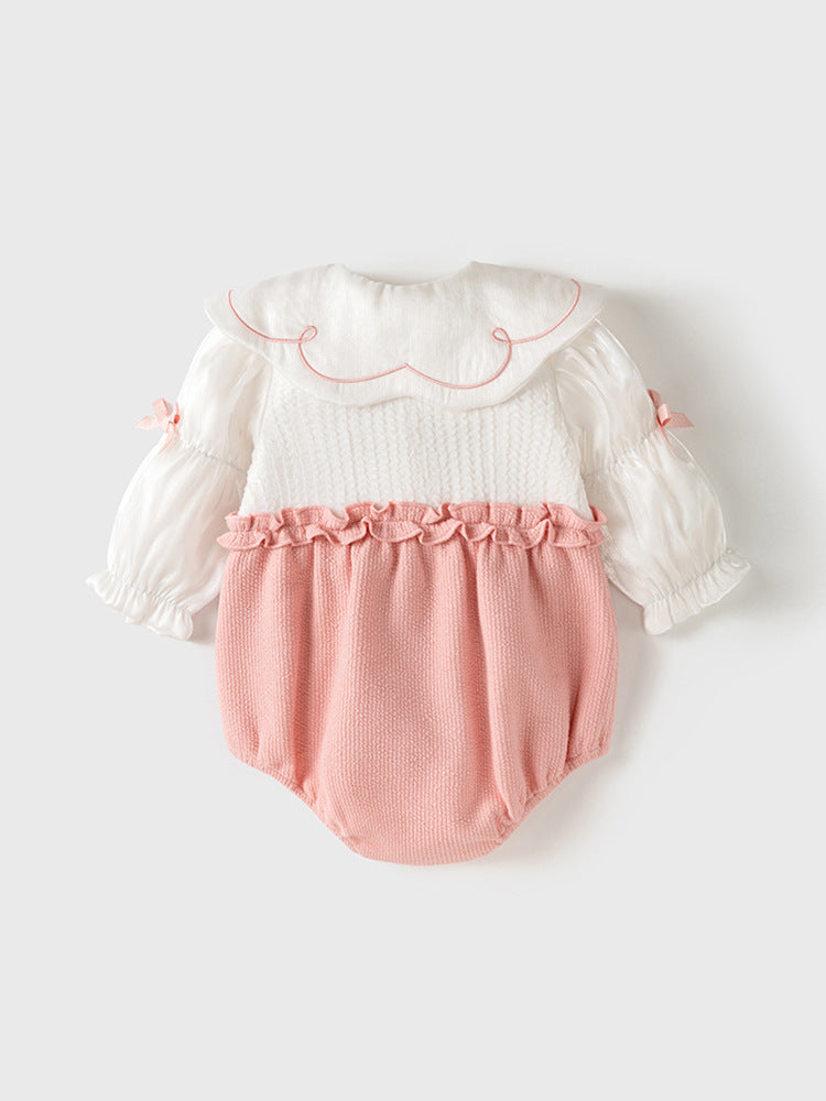 A pink baby girl's dress featuring floral embroidery on the collar and a patchwork pattern, perfect for autumn and spring wear.