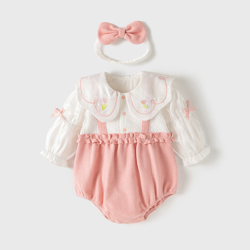 A pink baby girl's dress featuring floral embroidery on the collar and a patchwork pattern, perfect for autumn and spring wear.