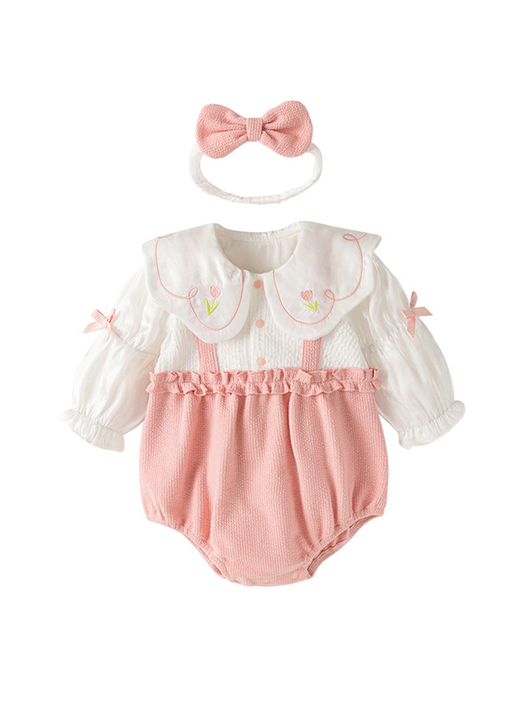 A pink baby girl's dress featuring floral embroidery on the collar and a patchwork pattern, perfect for autumn and spring wear.