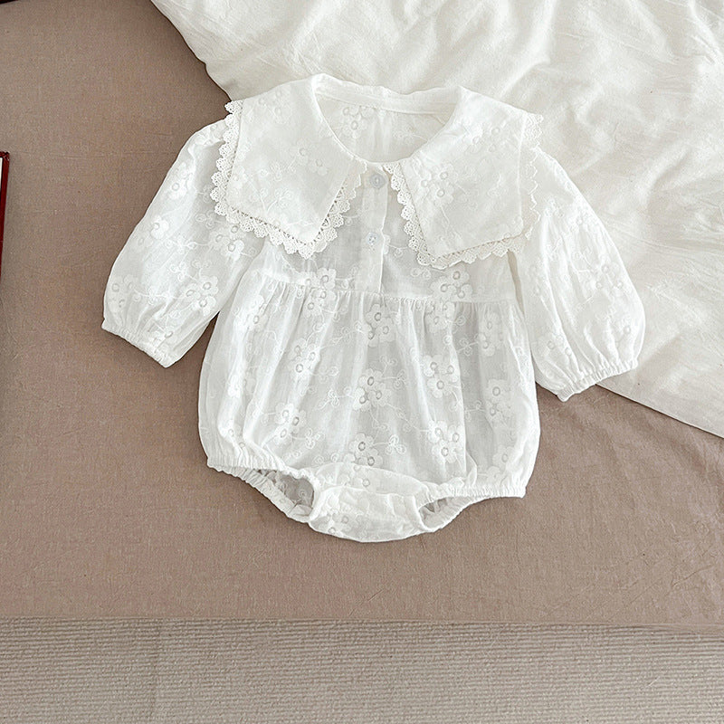 Baby girl wearing a long-sleeve floral patterned outfit in white, showcasing a stylish and comfortable design for autumn.