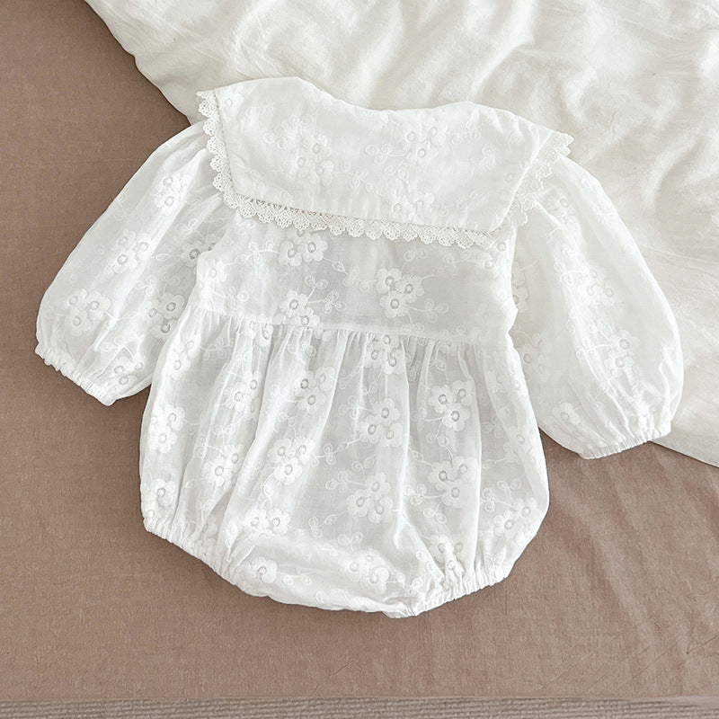 Baby girl wearing a long-sleeve floral patterned outfit in white, showcasing a stylish and comfortable design for autumn.