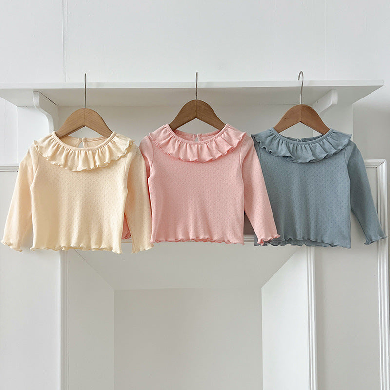 A collection of soft cotton outfits for baby girls in pink, blue, and apricot colors, perfect for autumn wear.