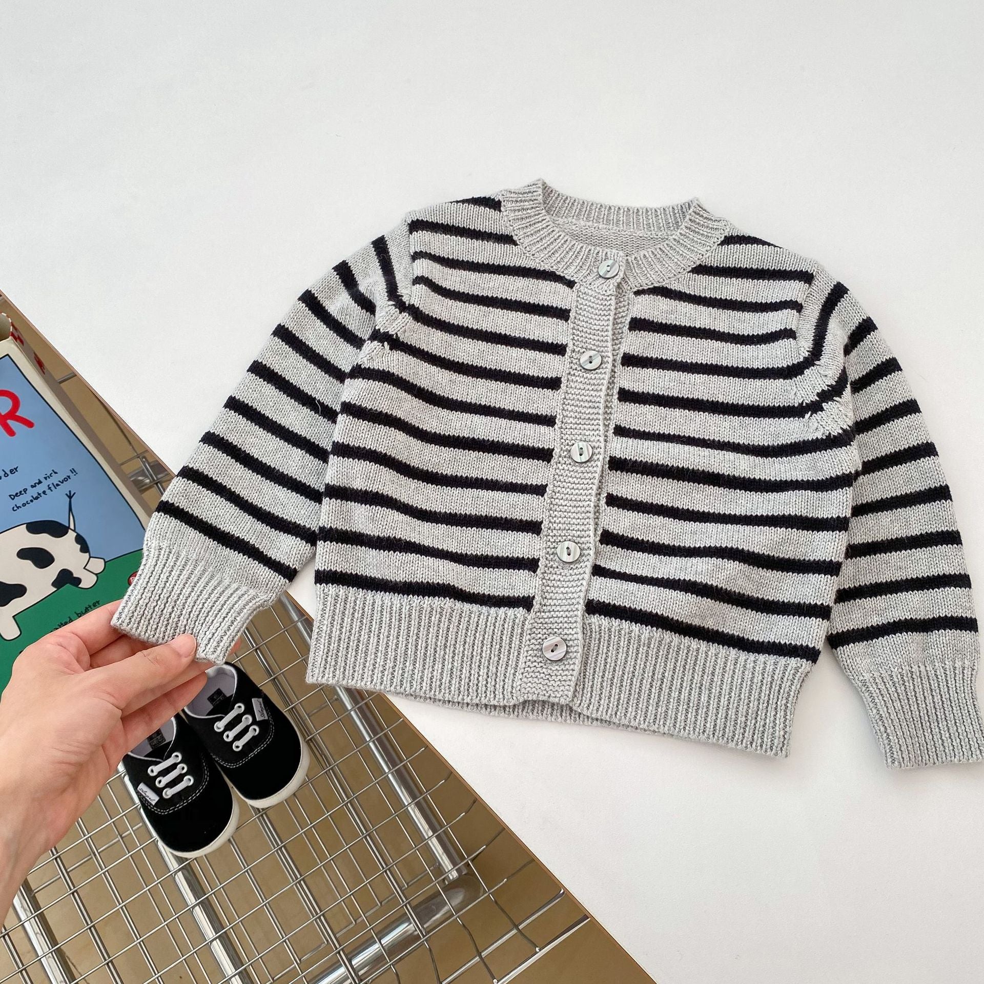 A stylish grey knitted overall set with striped pattern, perfect for autumn wear for babies.