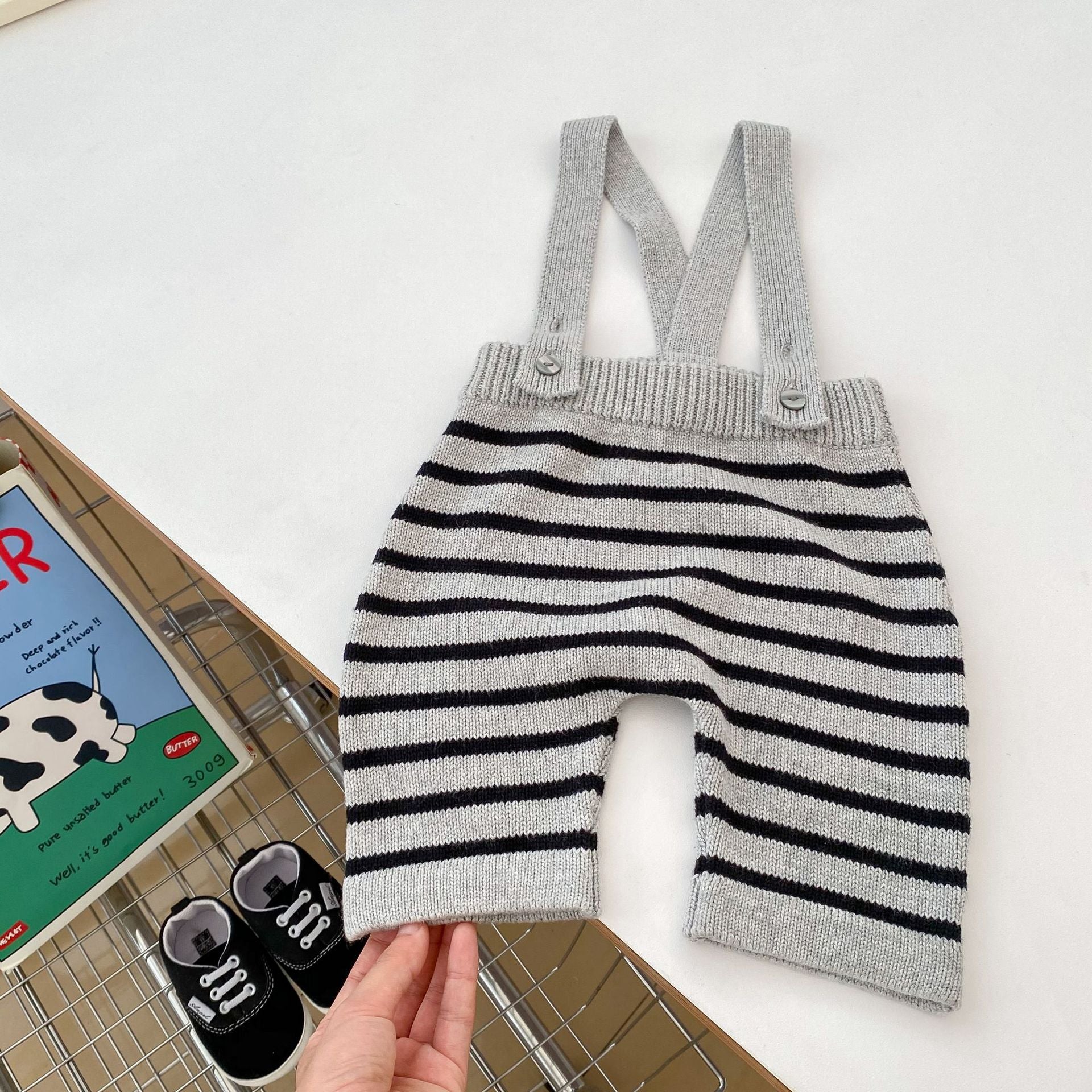 A stylish grey knitted overall set with striped pattern, perfect for autumn wear for babies.