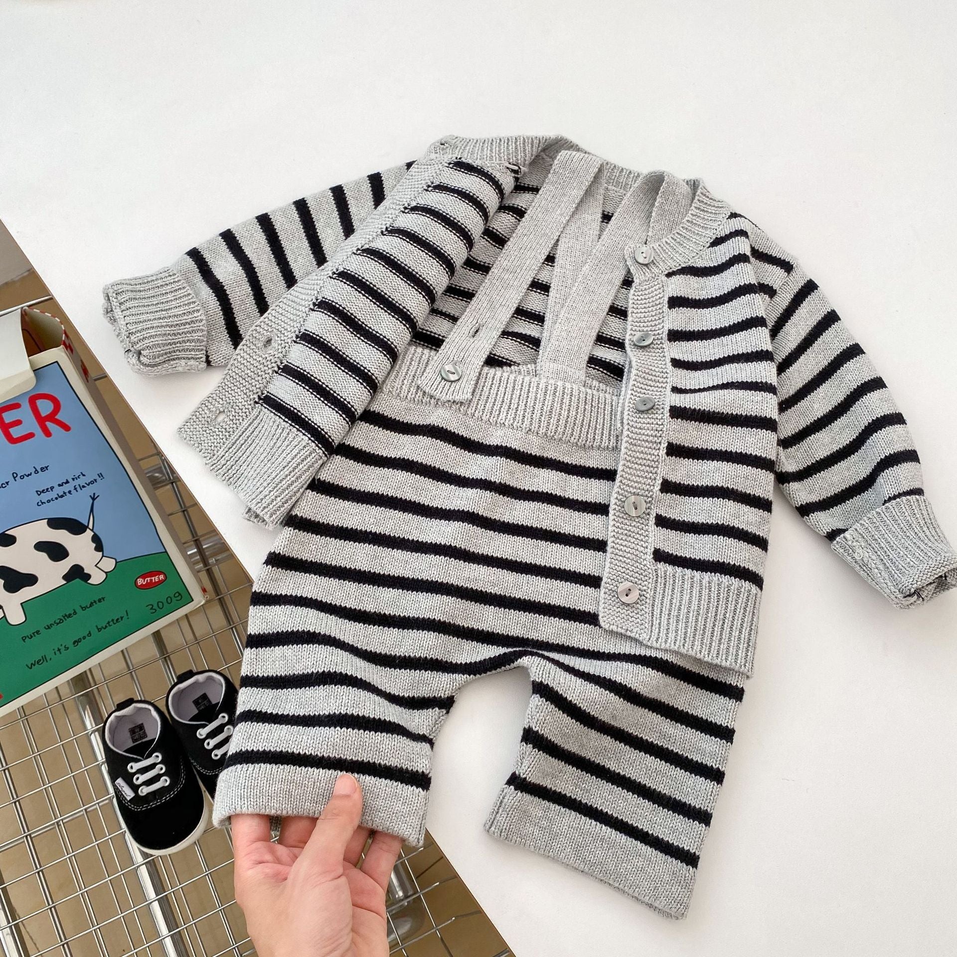 A stylish grey knitted overall set with striped pattern, perfect for autumn wear for babies.