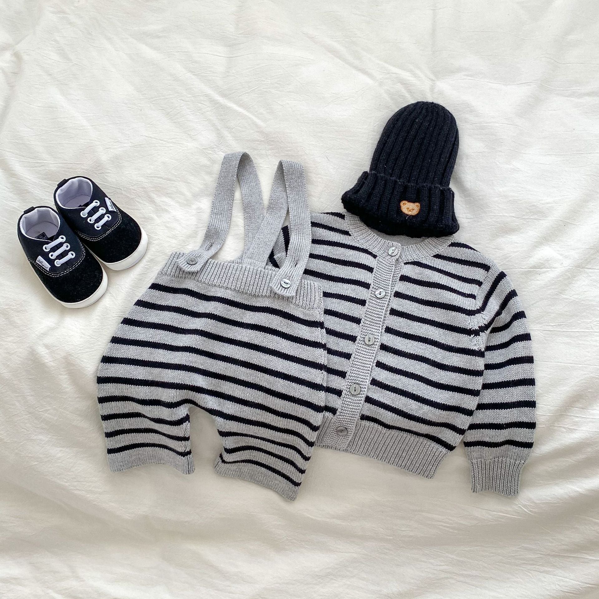 A stylish grey knitted overall set with striped pattern, perfect for autumn wear for babies.