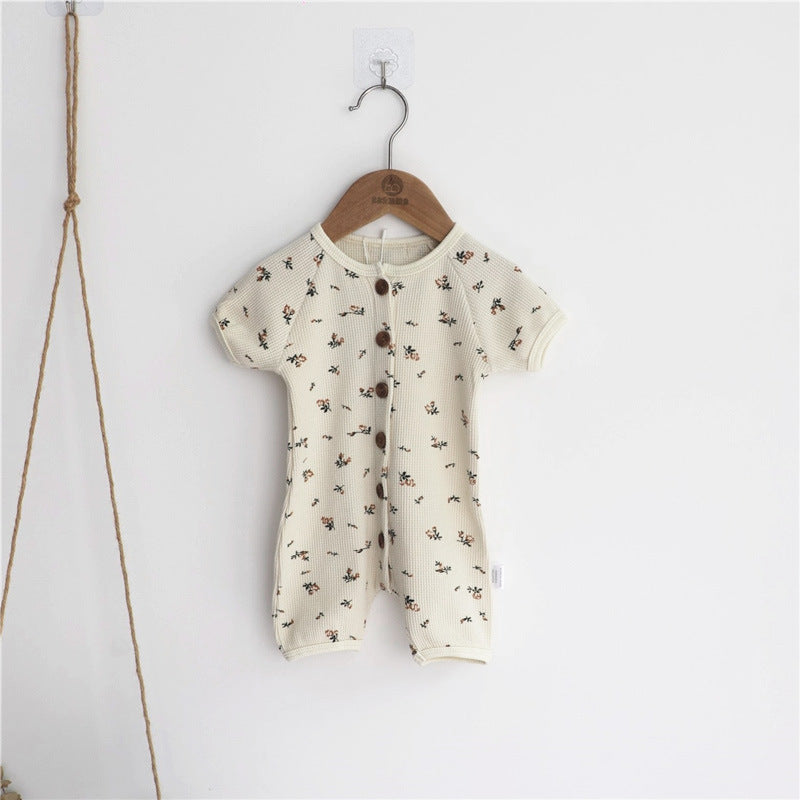 Baby jumpsuit featuring an allover floral graphic pattern and solid bodice, designed for comfort and style.