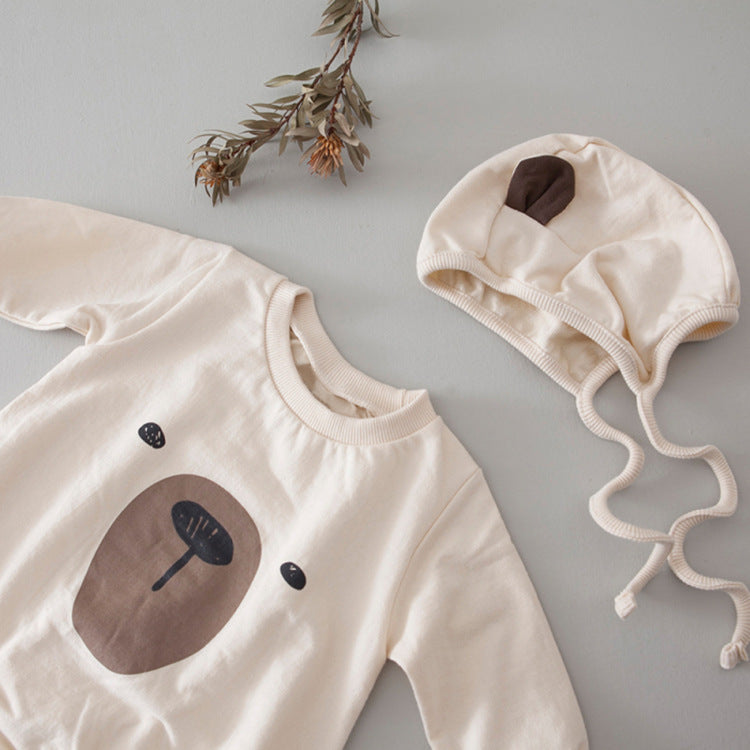 A cute baby wearing a Cartoon Bear Graphic Crotchet Jumpsuit in soft cotton, showcasing the adorable bear design.