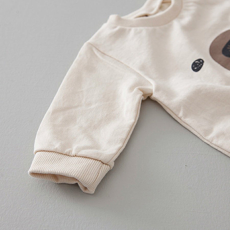 A cute baby wearing a Cartoon Bear Graphic Crotchet Jumpsuit in soft cotton, showcasing the adorable bear design.