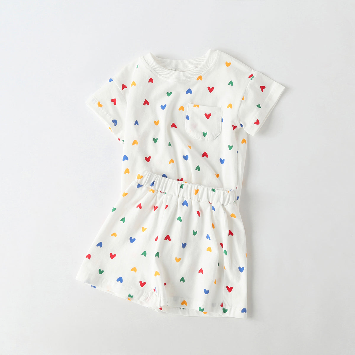 Baby outfit featuring plaid and heart patterns in a tee and shorts set, available in white and yellow colors.