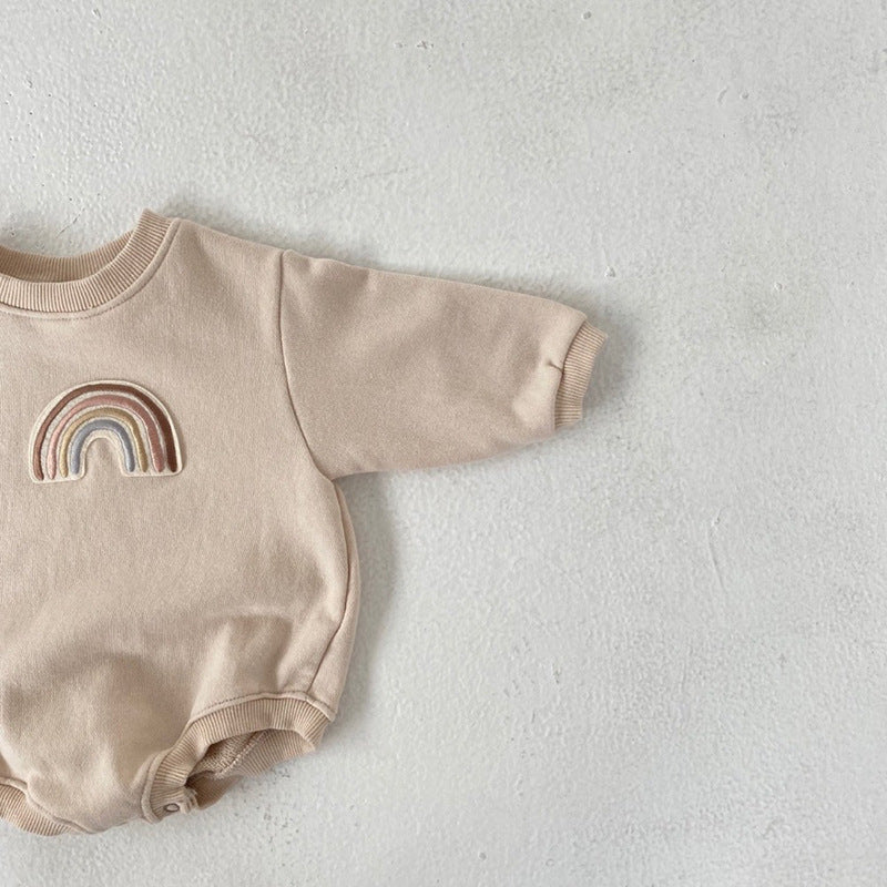 A soft cotton baby bodysuit featuring a rainbow embroidery pattern, available in apricot and coffee colors, designed for comfort and style.