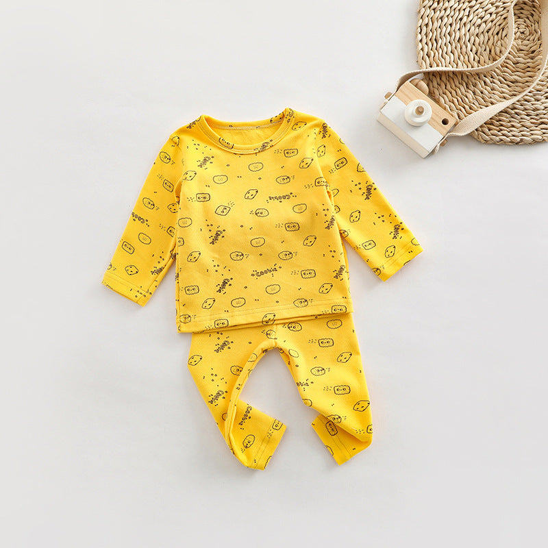 A cute baby outfit set featuring all-over print patterns in pink, yellow, and apricot colors, made from soft cotton material.