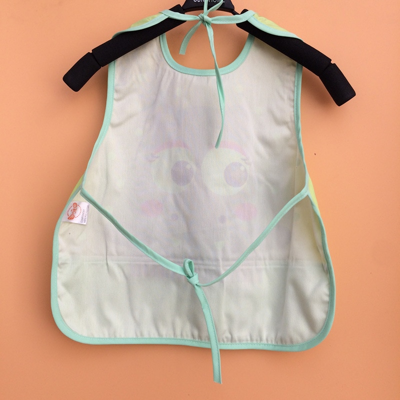 Mint green children's apron hanging.