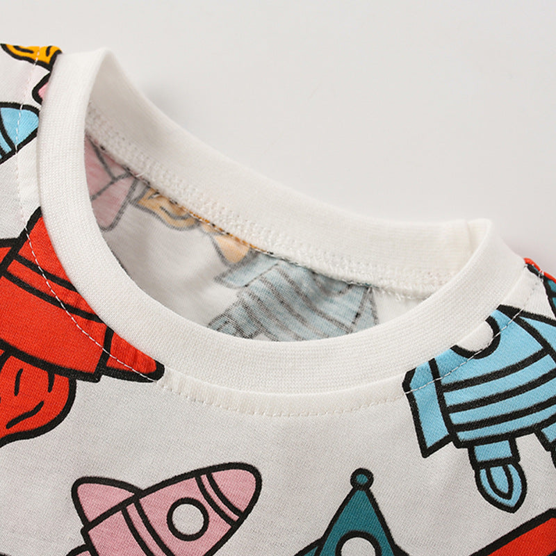 Baby boy's round neck tee featuring an all-over rocket pattern in white cotton fabric, perfect for summer wear.