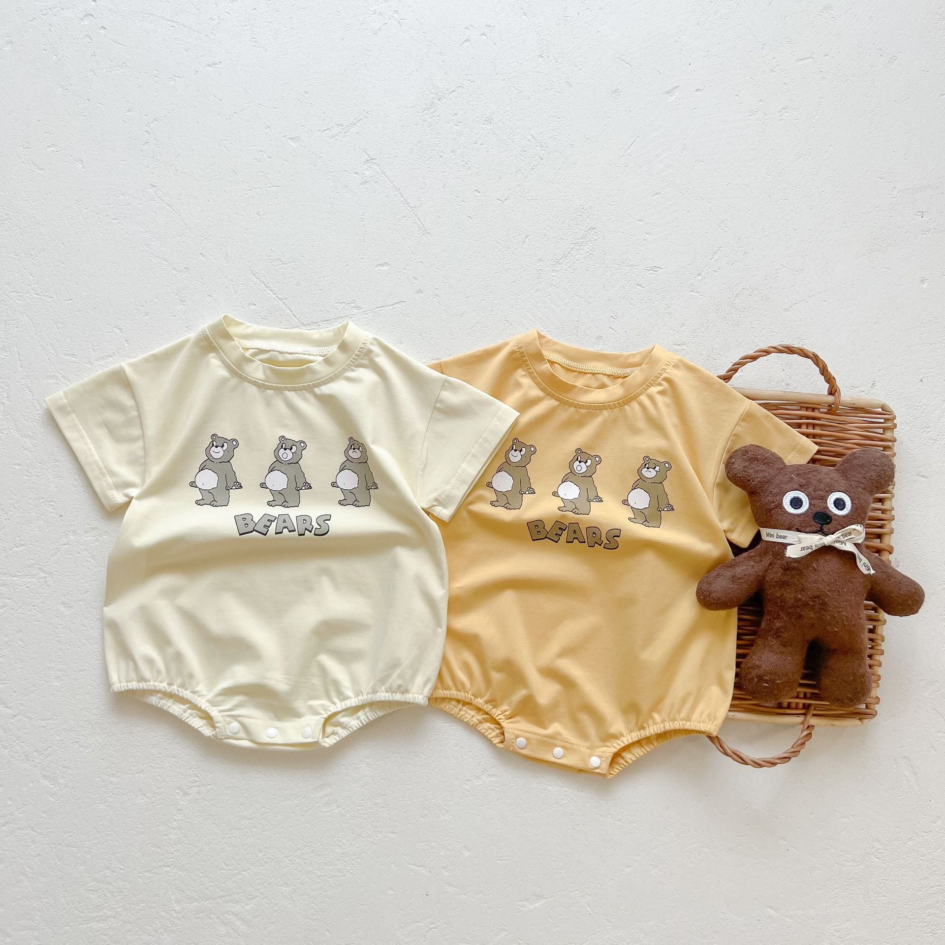 Baby boy and girl bear print onesies in white and yellow colors, featuring a cozy O-neck design made from soft cotton material.