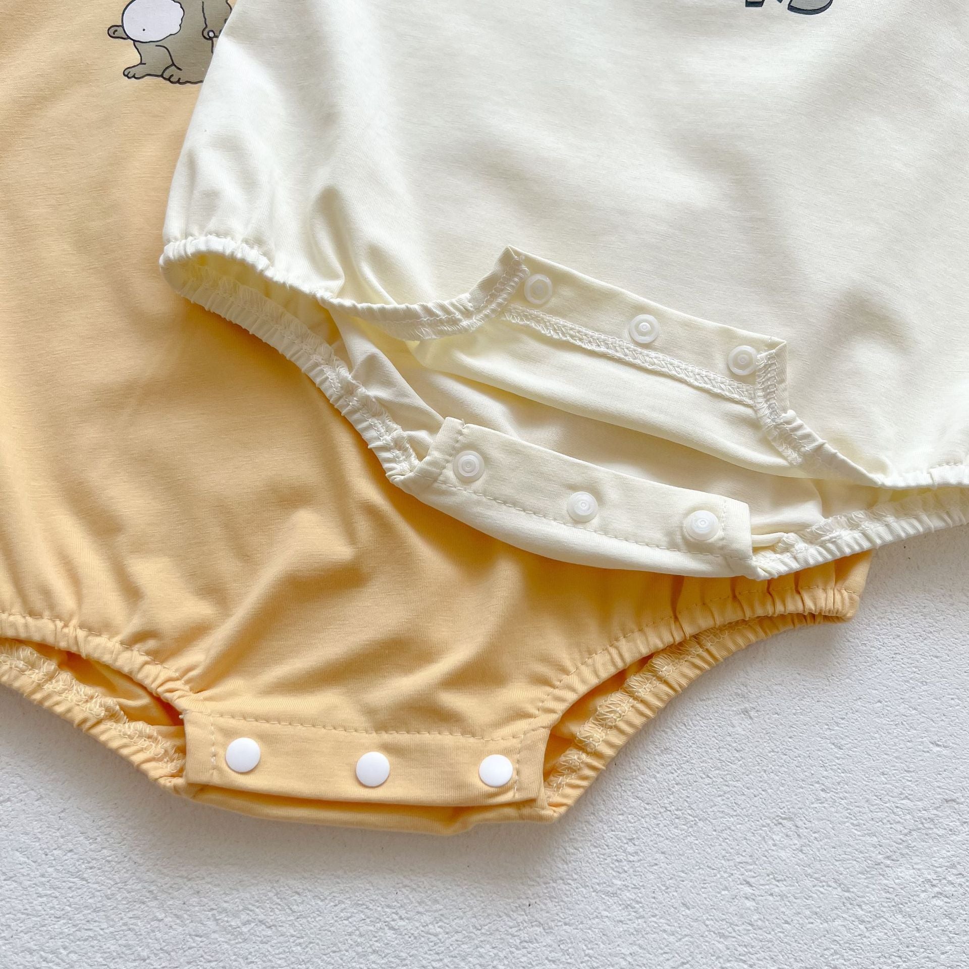 Baby boy and girl bear print onesies in white and yellow colors, featuring a cozy O-neck design made from soft cotton material.