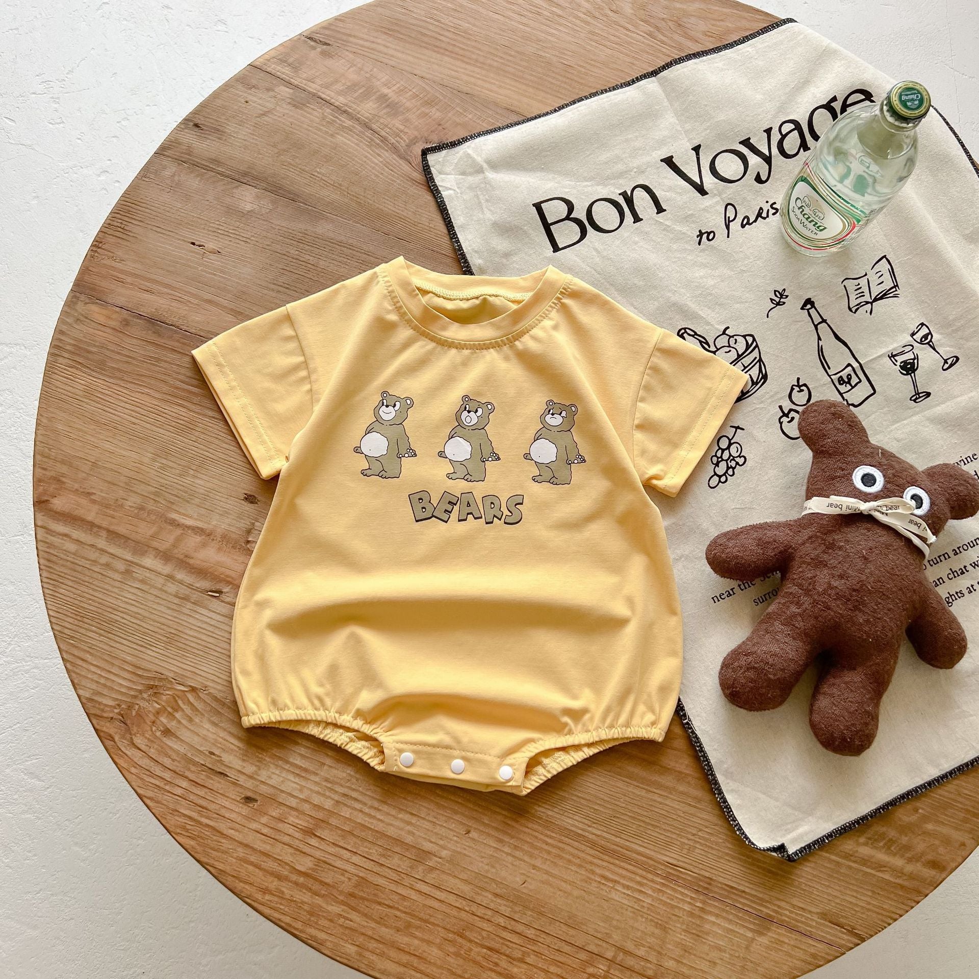 Baby boy and girl bear print onesies in white and yellow colors, featuring a cozy O-neck design made from soft cotton material.