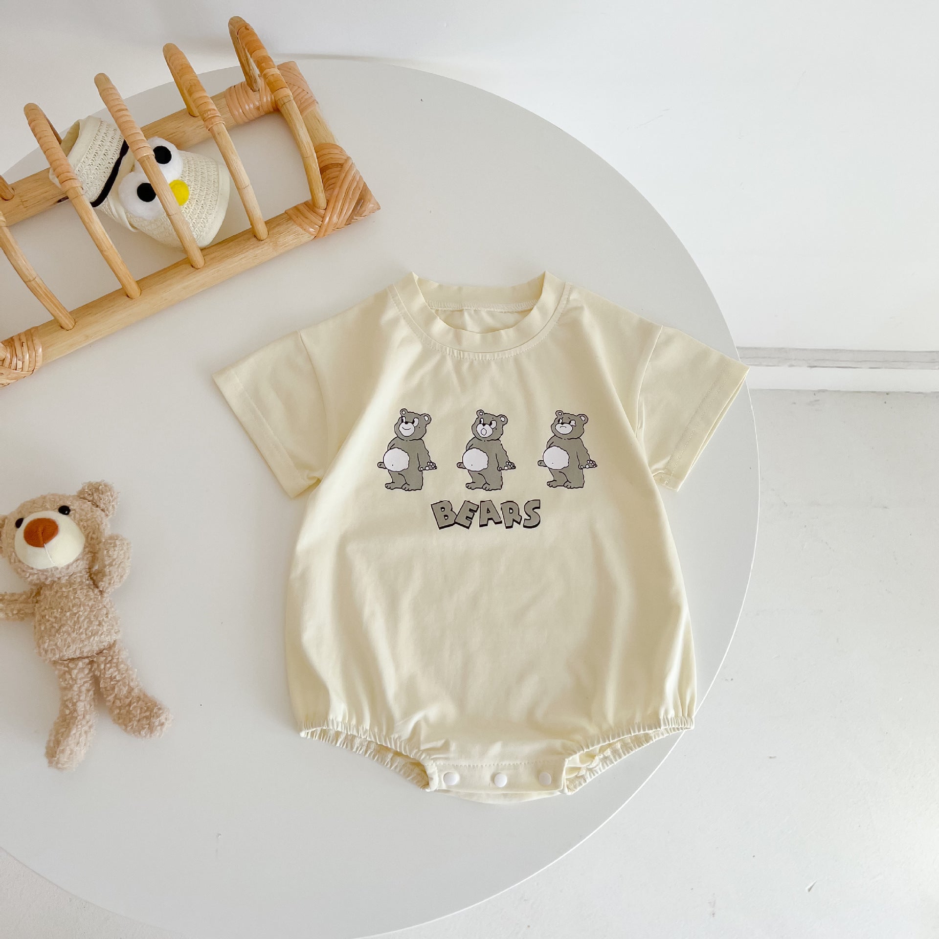 Baby boy and girl bear print onesies in white and yellow colors, featuring a cozy O-neck design made from soft cotton material.