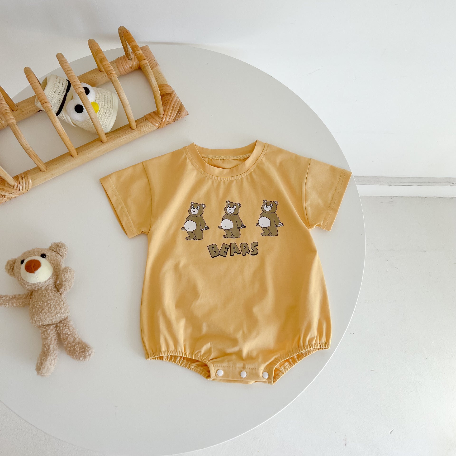 Baby boy and girl bear print onesies in white and yellow colors, featuring a cozy O-neck design made from soft cotton material.