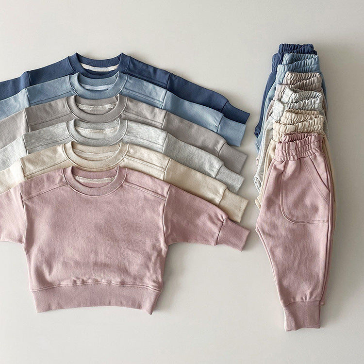 Baby boy and girl solid color pullover hoodies combo pants sets in pink, grey, and apricot, made from soft cotton for comfort.