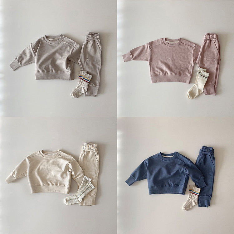 Baby boy and girl solid color pullover hoodies combo pants sets in pink, grey, and apricot, made from soft cotton for comfort.