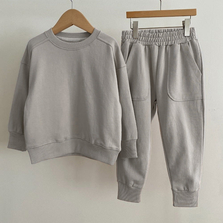 Baby boy and girl solid color pullover hoodies combo pants sets in pink, grey, and apricot, made from soft cotton for comfort.