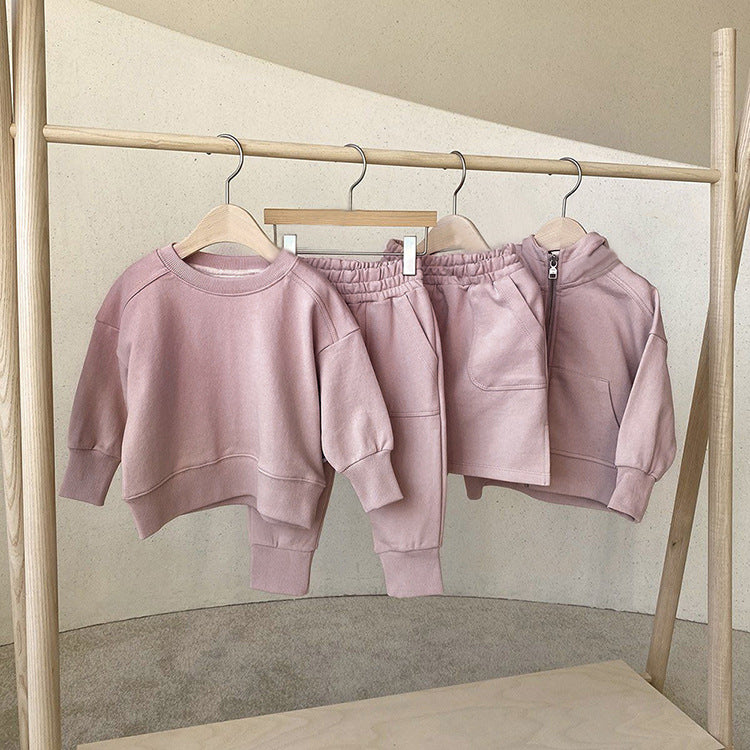 Baby boy and girl solid color pullover hoodies combo pants sets in pink, grey, and apricot, made from soft cotton for comfort.