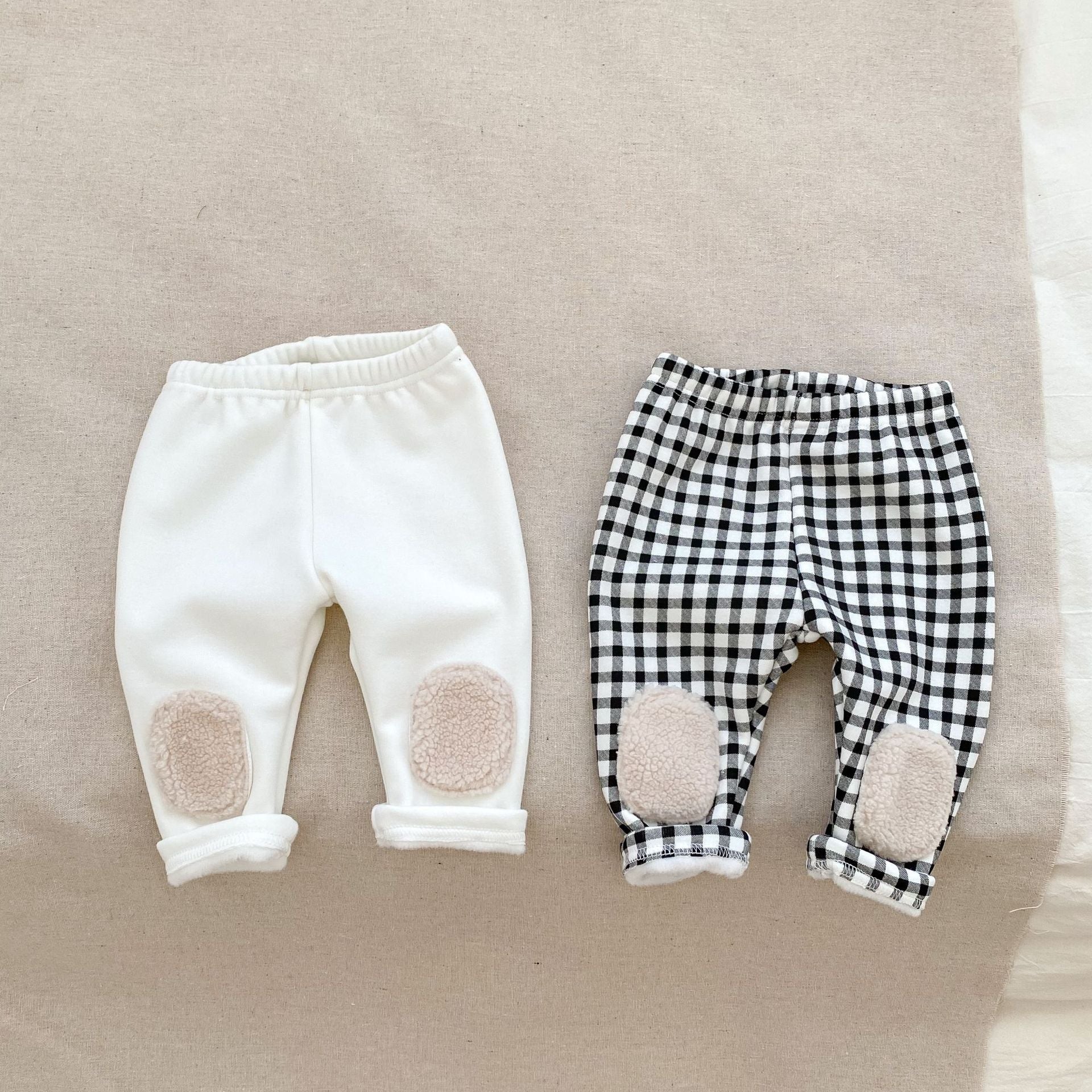 High waist thickened long pants for baby boys and girls in white and black colors, perfect for winter wear.