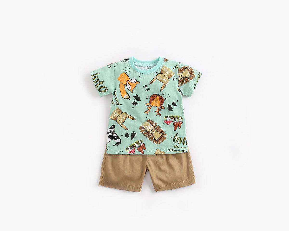 Baby boy wearing a vibrant green animal print top and solid color shorts, perfect for summer outings.