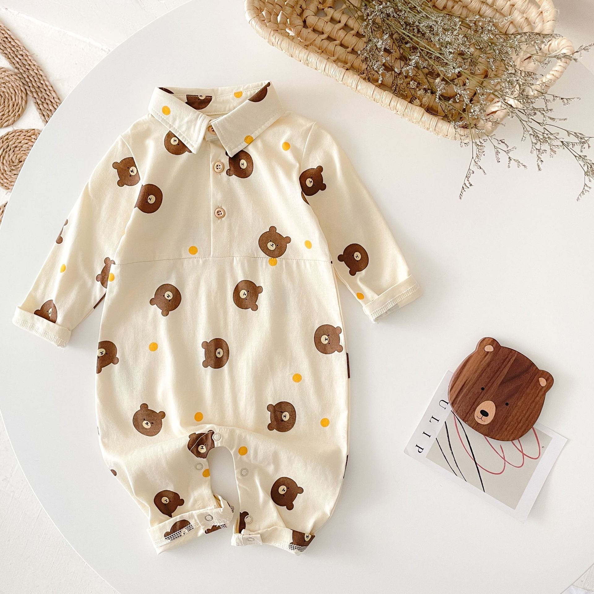 Baby boy wearing a bear pattern long sleeve polo collar romper in apricot color, showcasing a stylish and comfortable design.