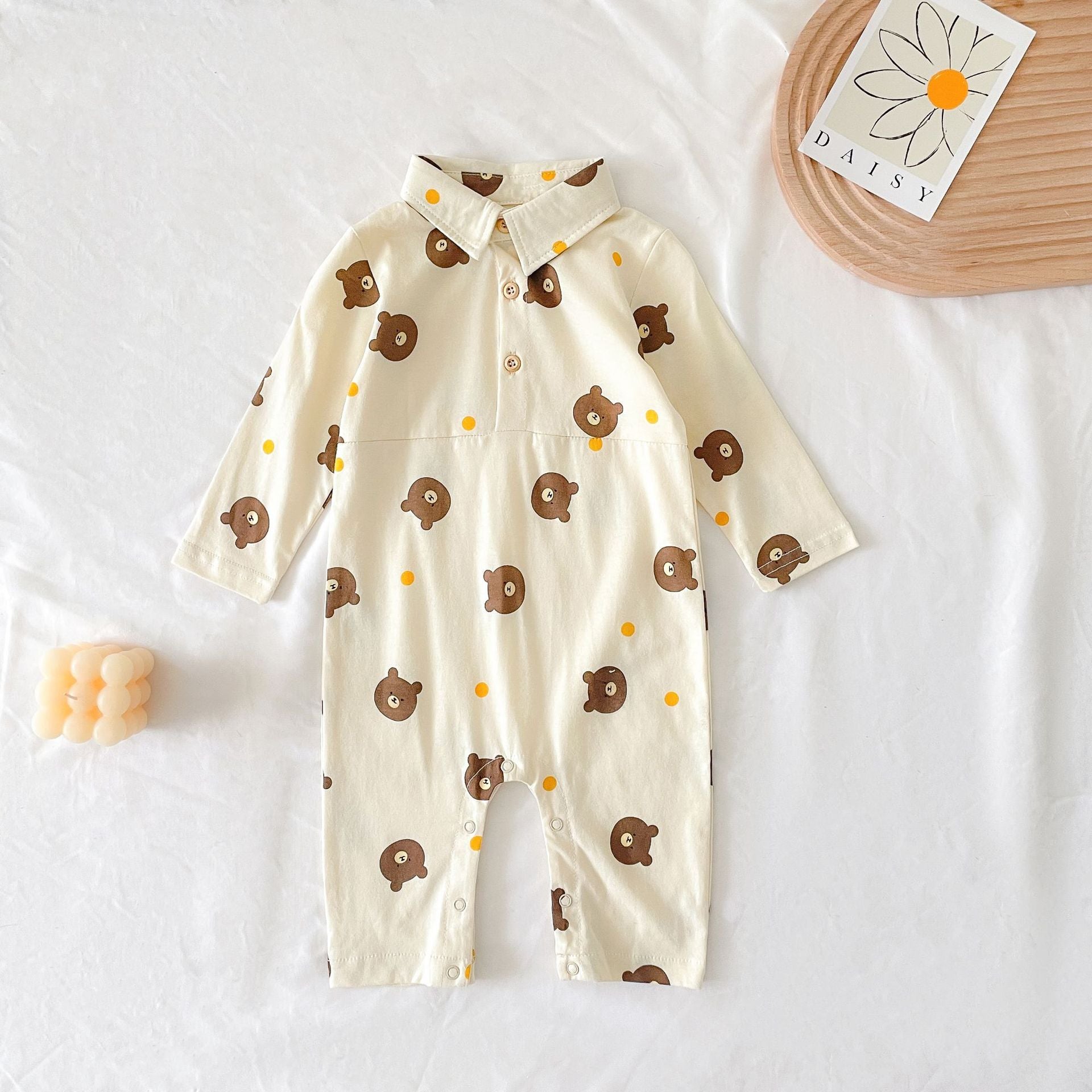 Baby boy wearing a bear pattern long sleeve polo collar romper in apricot color, showcasing a stylish and comfortable design.