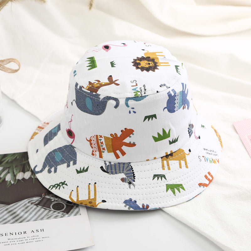 Baby boy wearing a cartoon animal and cactus pattern sunshade bowl hat, showcasing its vibrant colors and adjustable chin strap.