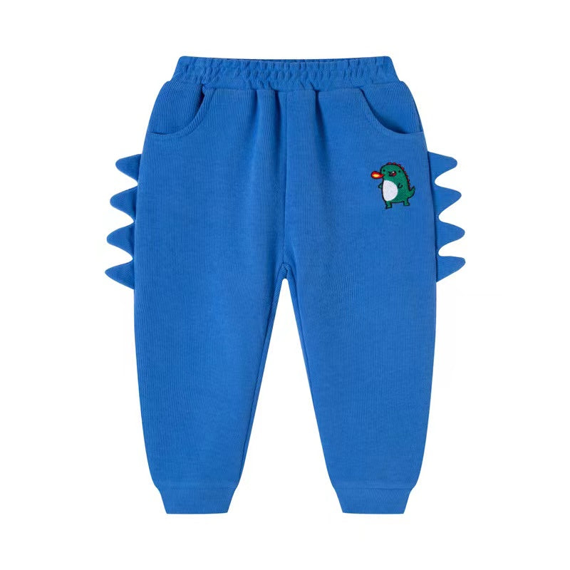 Baby boy wearing cartoon dinosaur embroidered trousers with 3D horn patches in navy blue color, showcasing playful design and comfort.