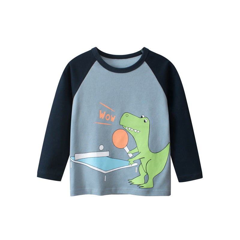 Baby boy wearing a blue cartoon dinosaur pattern colorblock shirt, showcasing vibrant colors and playful design.