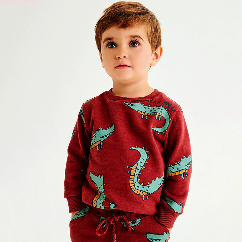 A vibrant red hoodie for baby boys featuring a playful cartoon dinosaur pattern, made from soft cotton for comfort and warmth.