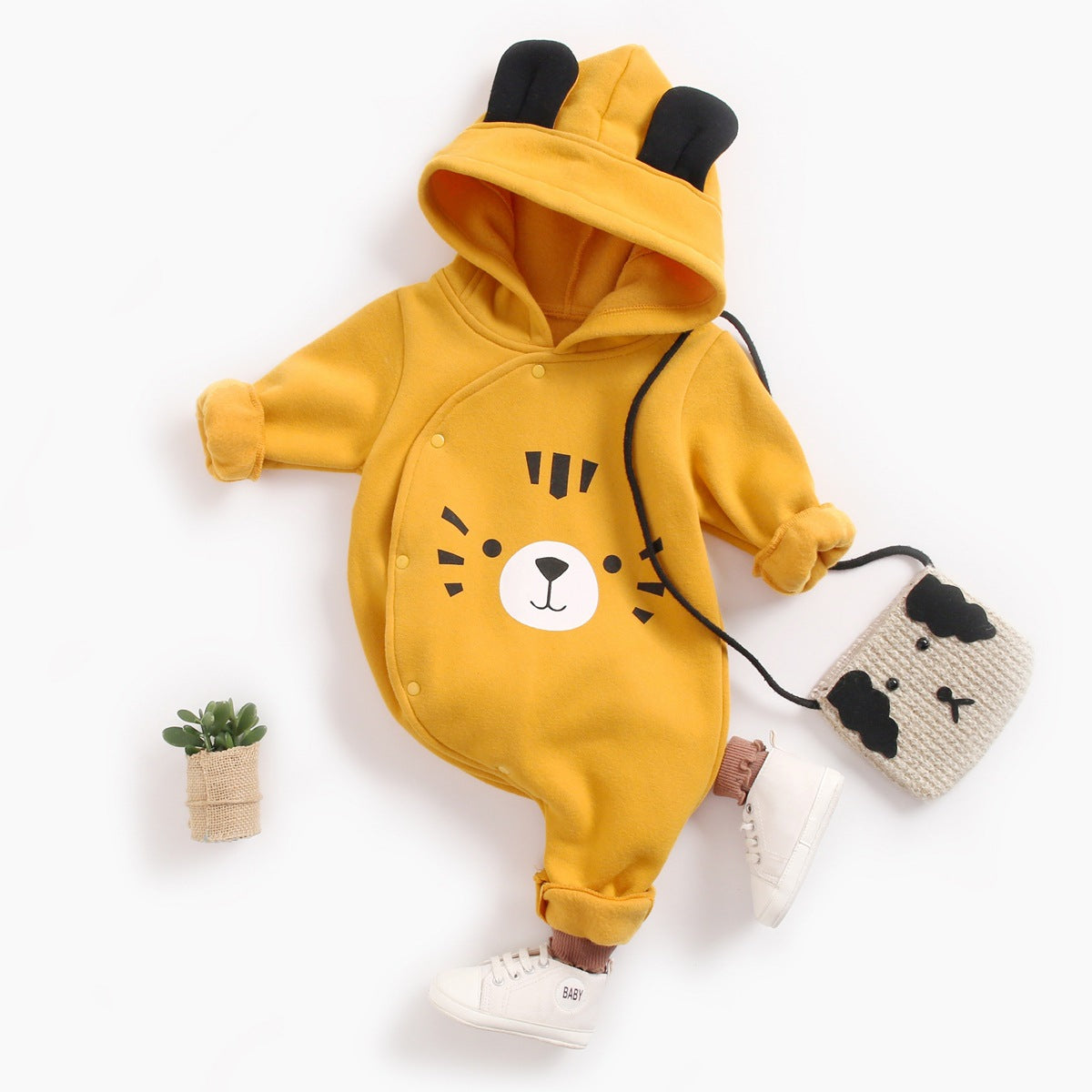 Baby boy wearing a vibrant cartoon pattern longsleeve romper with side buttons and a matching hat, showcasing a cheerful yellow color.