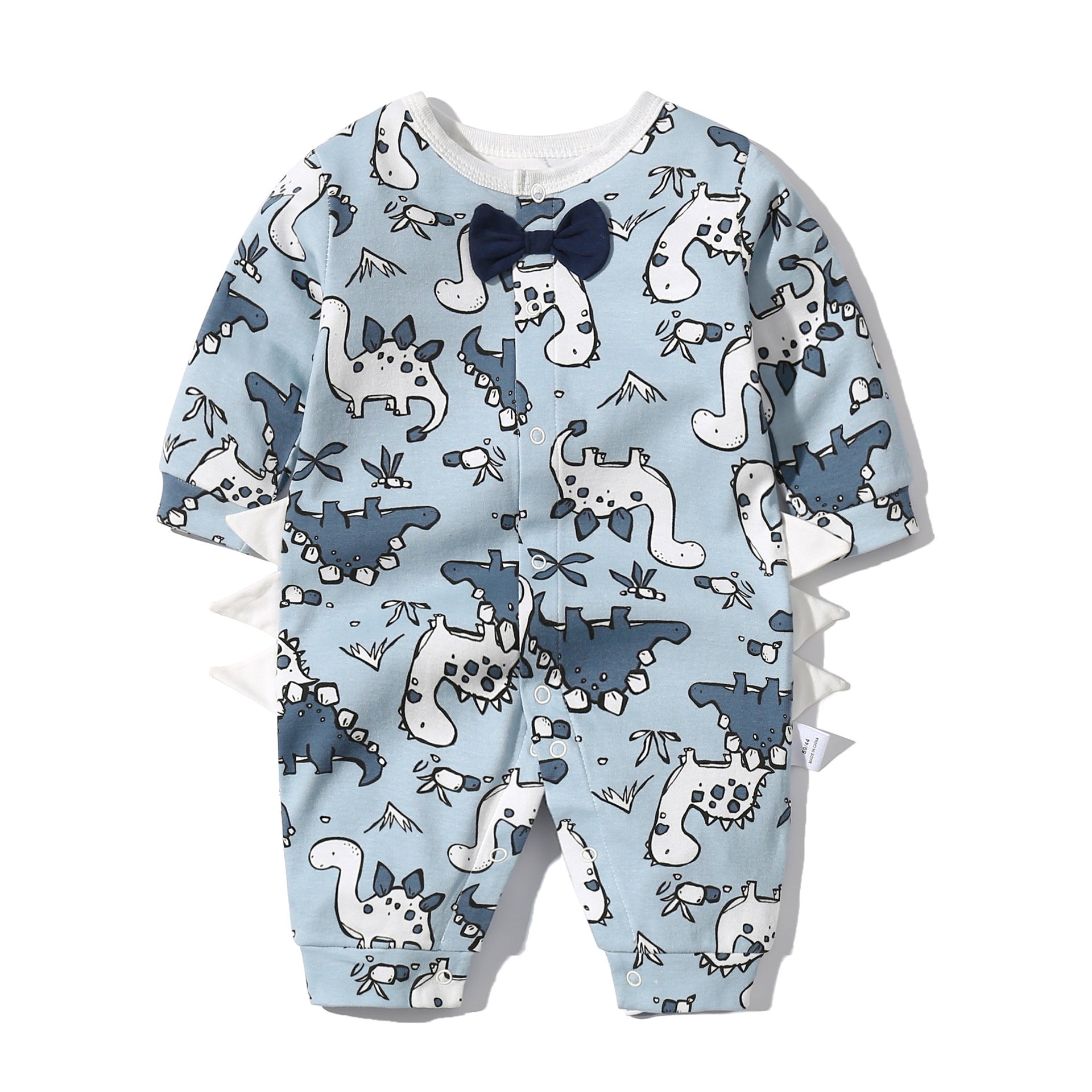 Baby boy wearing a dinosaur patterned bow tie romper with snap button closure, featuring a fun patched design.