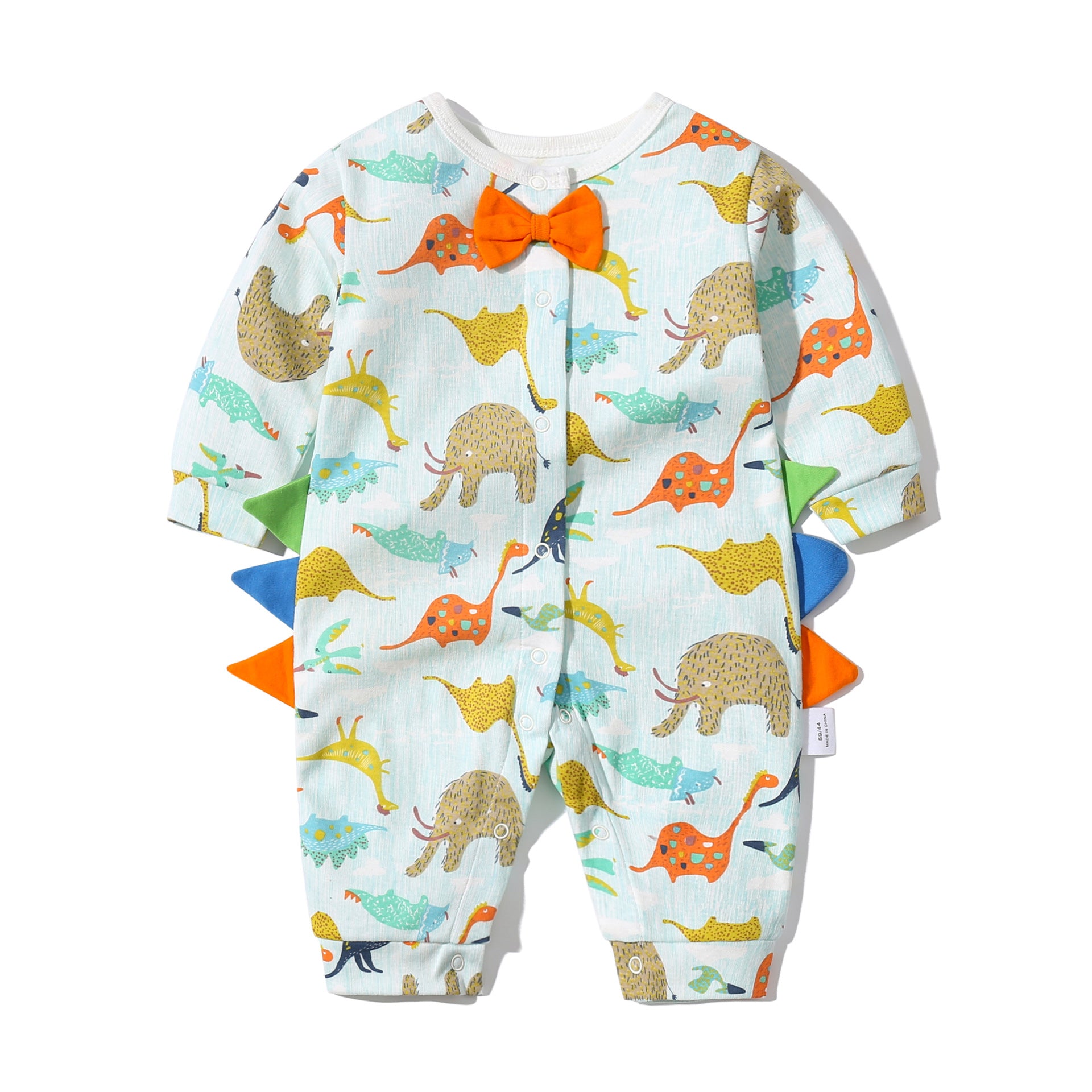 Baby boy wearing a dinosaur patterned bow tie romper with snap button closure, featuring a fun patched design.