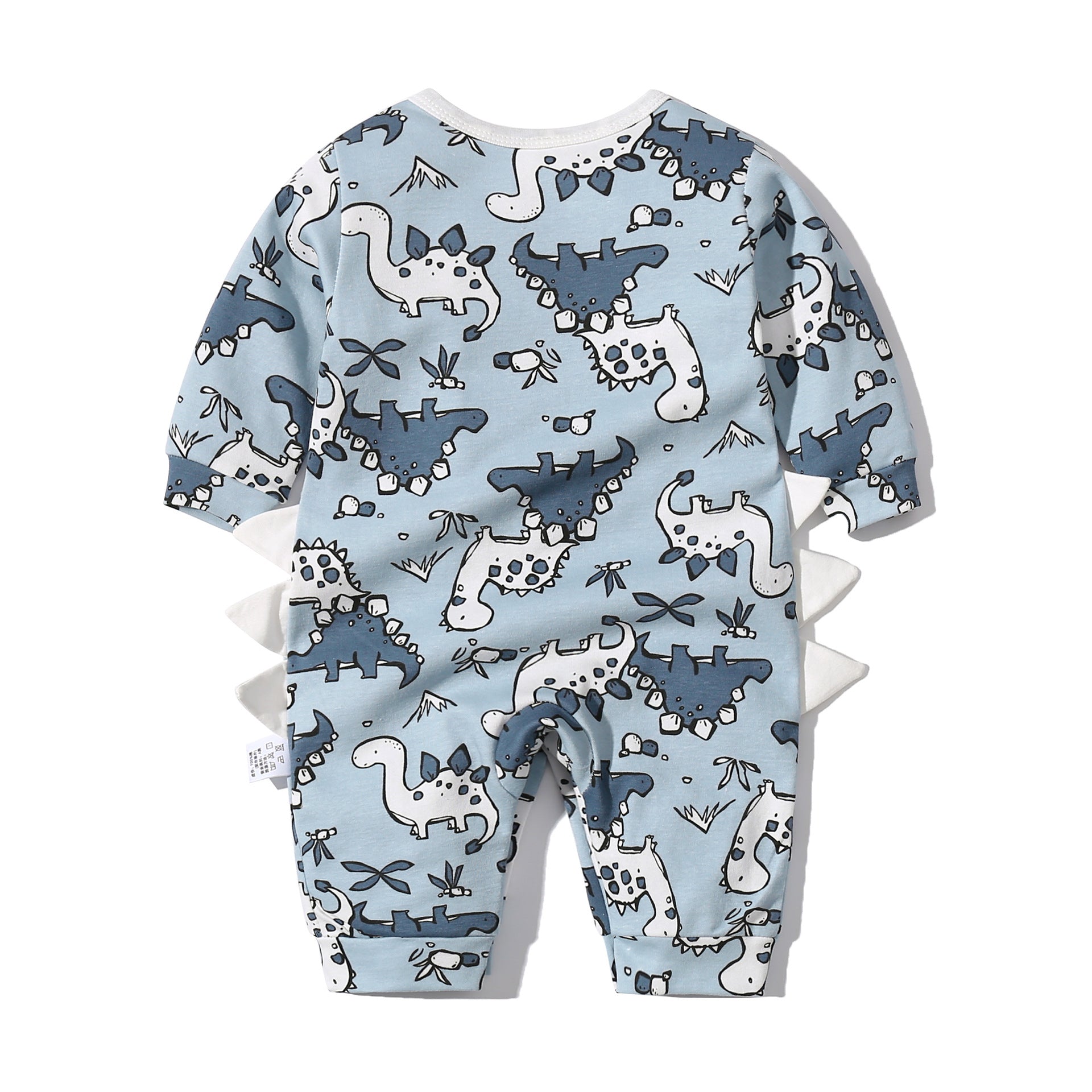 Baby boy wearing a dinosaur patterned bow tie romper with snap button closure, featuring a fun patched design.