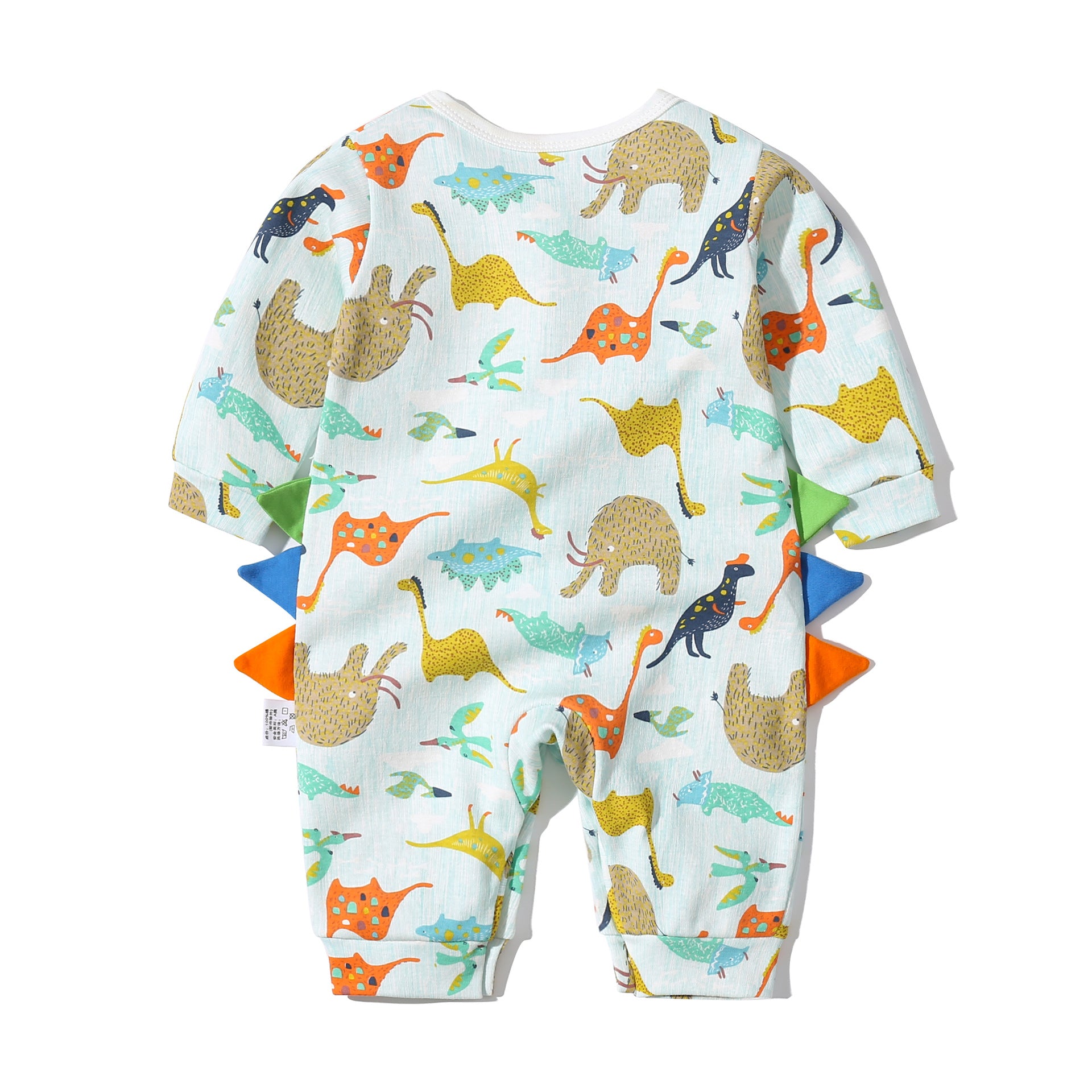 Baby boy wearing a dinosaur patterned bow tie romper with snap button closure, featuring a fun patched design.