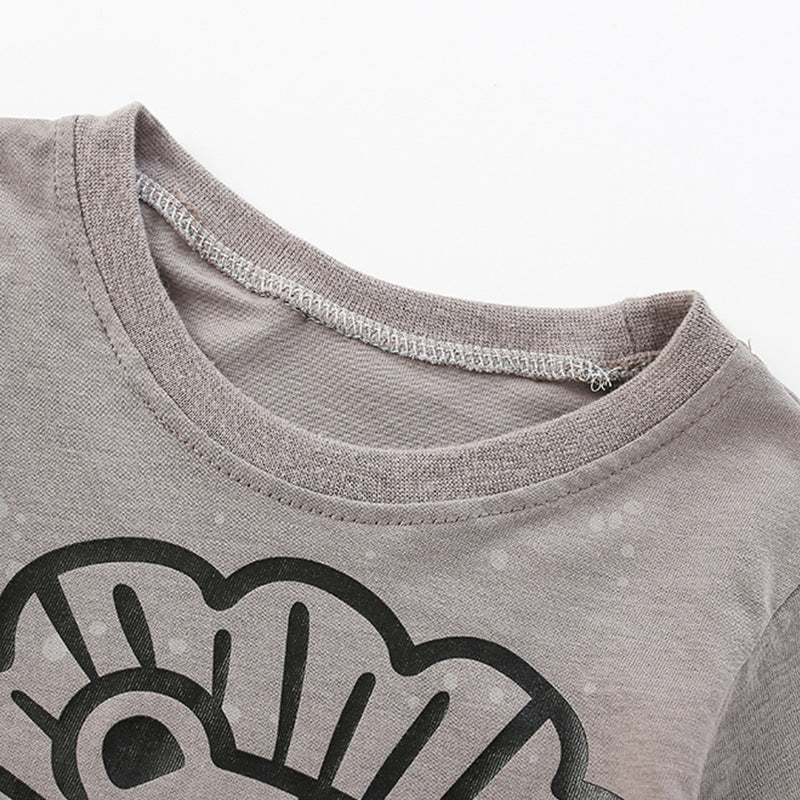 A soft cotton shirt for baby boys featuring a playful lion pattern in grey, perfect for spring and autumn wear.