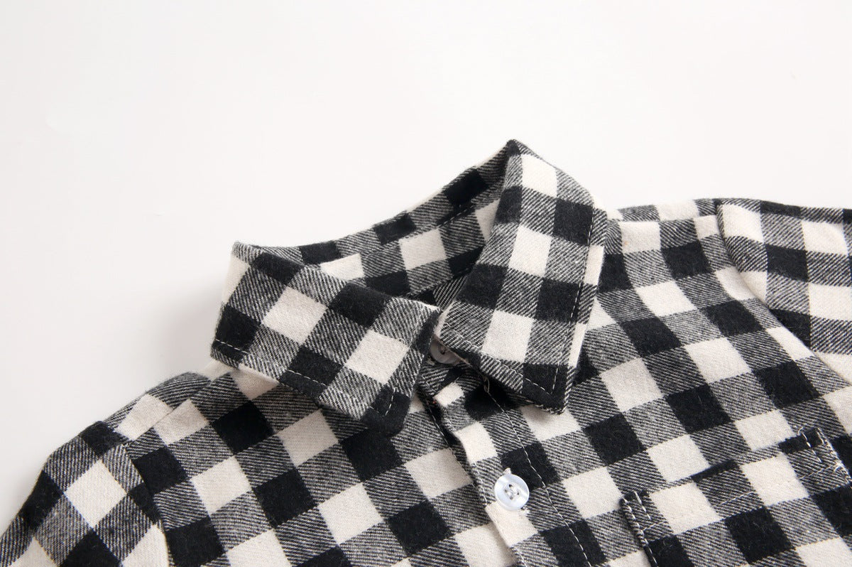 Baby boy wearing a plaid pattern buttoned shirt onesie with pockets, showcasing a stylish and comfortable design.