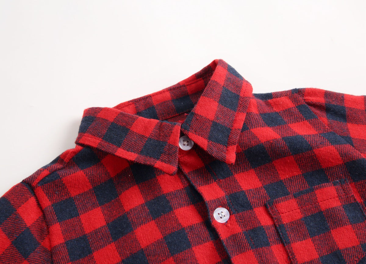 Baby boy wearing a plaid pattern buttoned shirt onesie with pockets, showcasing a stylish and comfortable design.