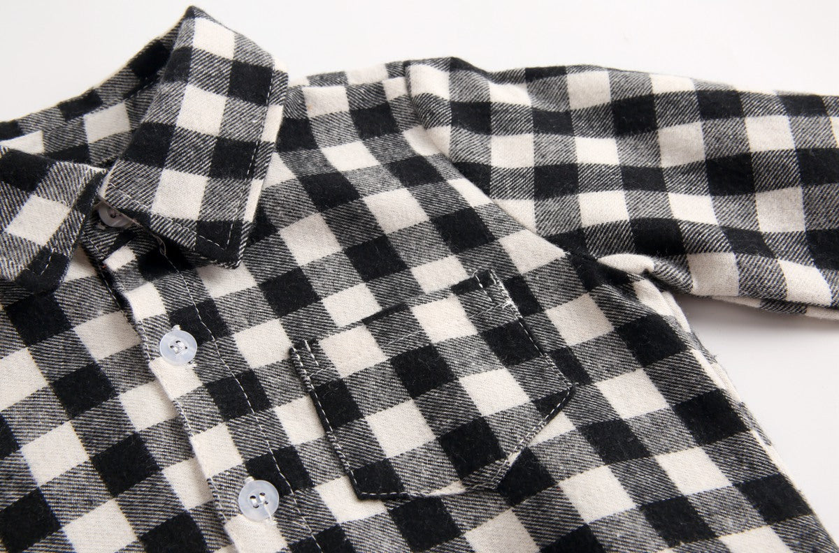 Baby boy wearing a plaid pattern buttoned shirt onesie with pockets, showcasing a stylish and comfortable design.