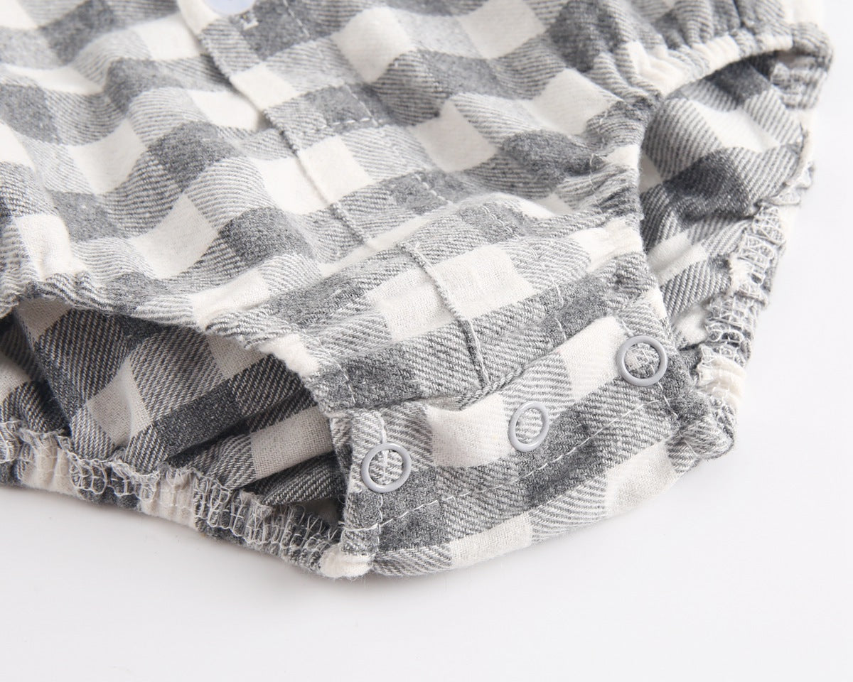 Baby boy wearing a plaid pattern buttoned shirt onesie with pockets, showcasing a stylish and comfortable design.